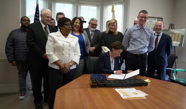  Raimondo Signs Legislation Raising Minimum Wage in Rhode Island